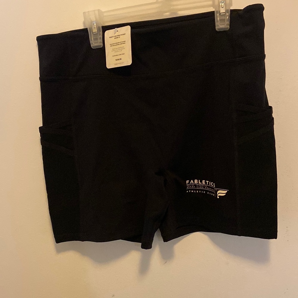 Never worn, tags on Fabletics trinity mid-rise pocket 5” compression shorts